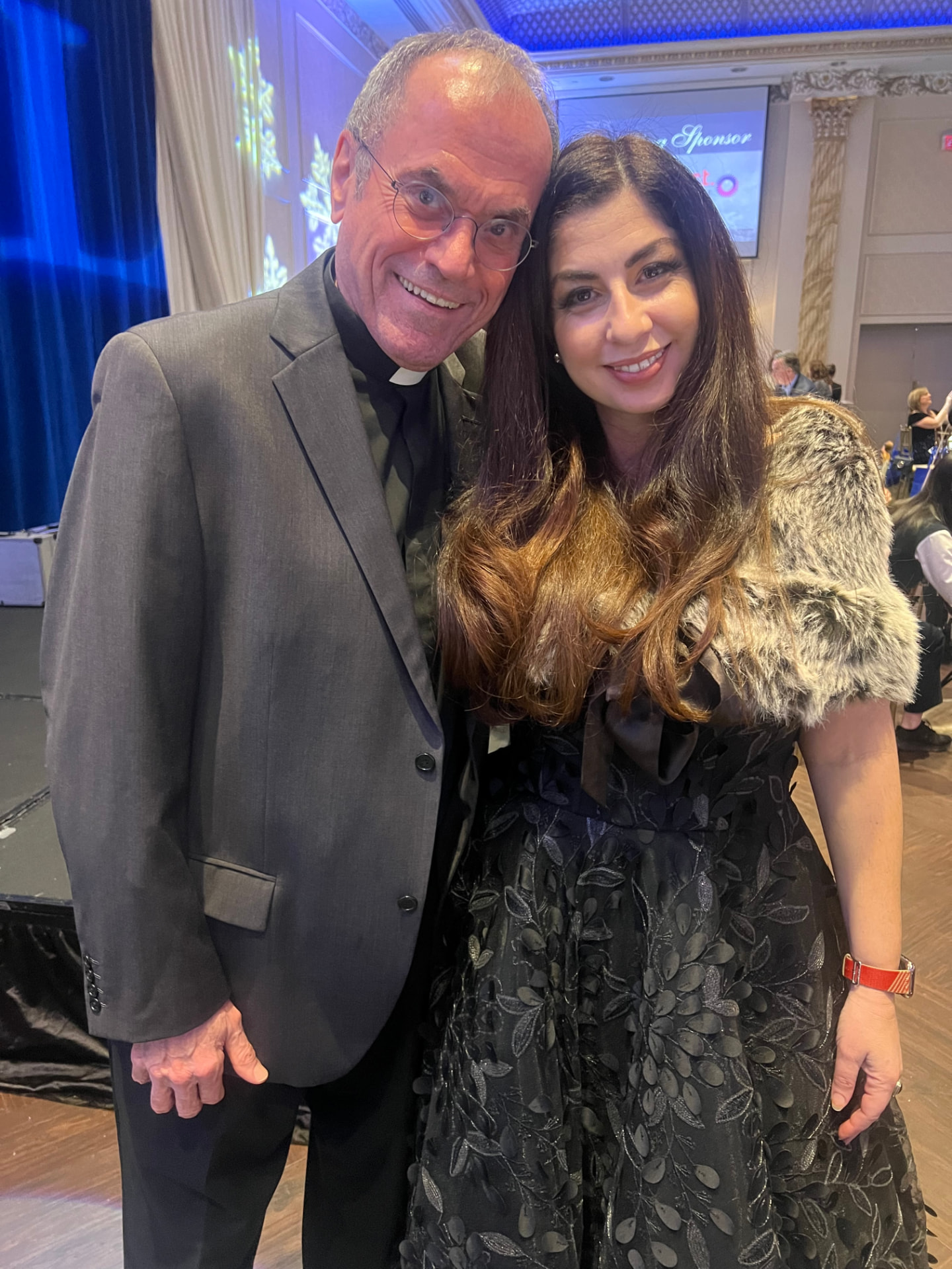 Ida Li Preti with a Catholic priest at a community event