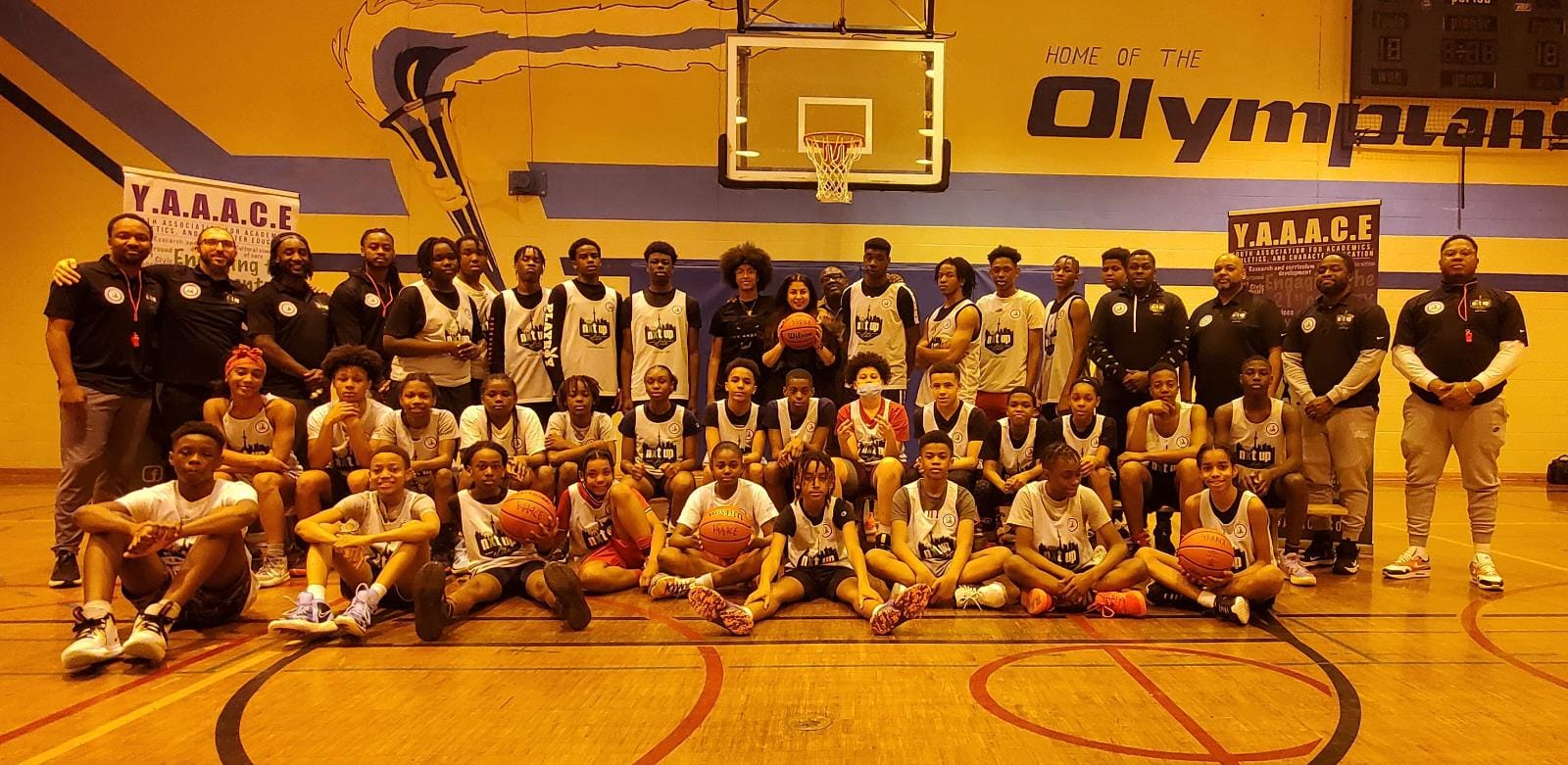 Students taking part in YAAACE basketball and academic programming in a school gymnasium