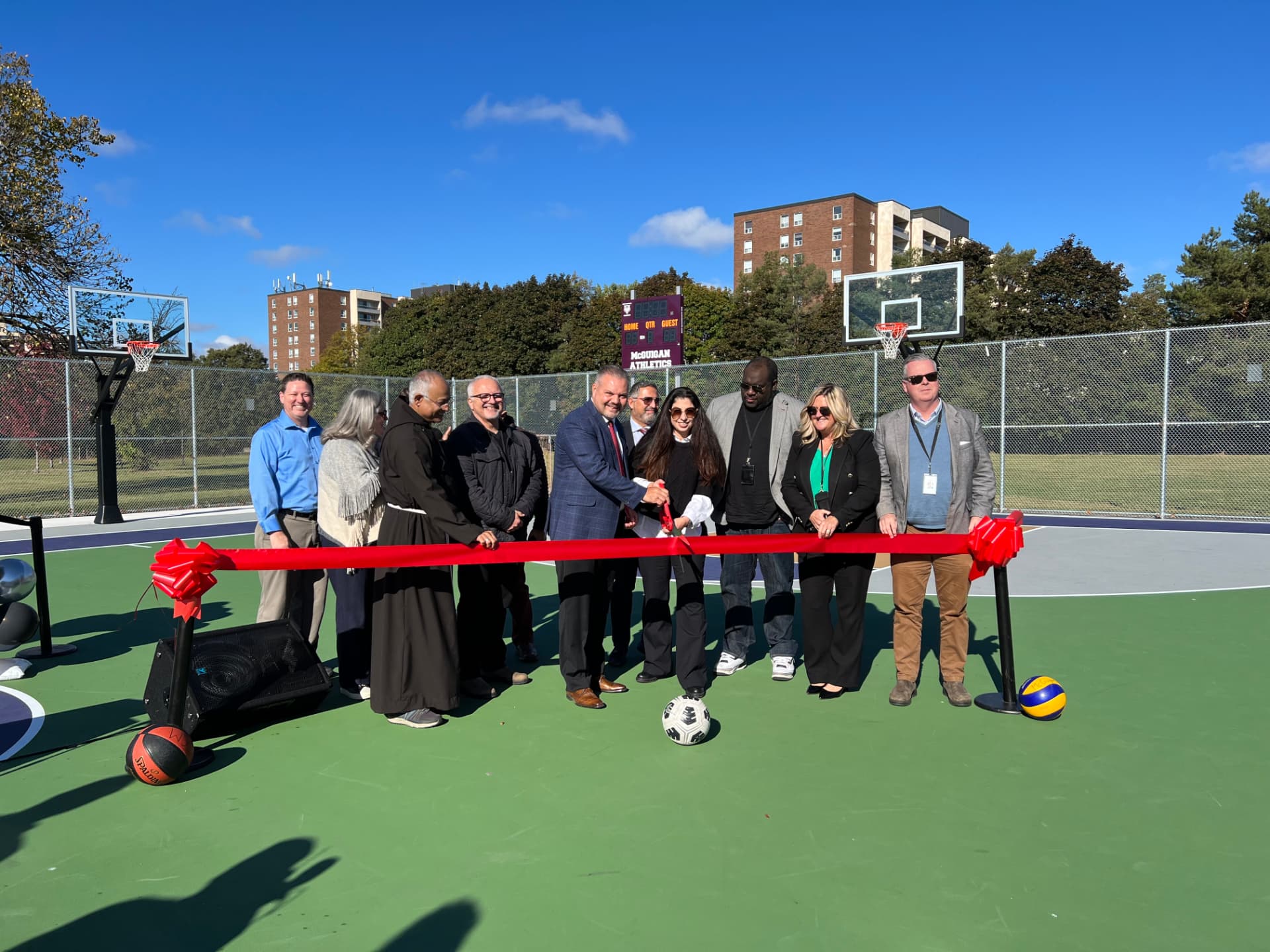 Ida Li Preti taking part in a ribbon cutting for a new outdoor sport court