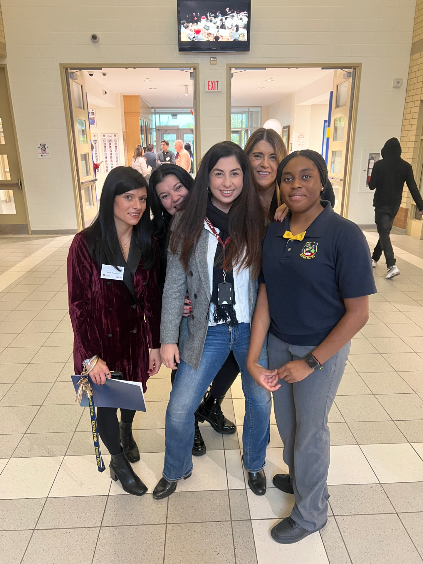Ida Li Preti with school staff and a student in a Ward 3 school hallway